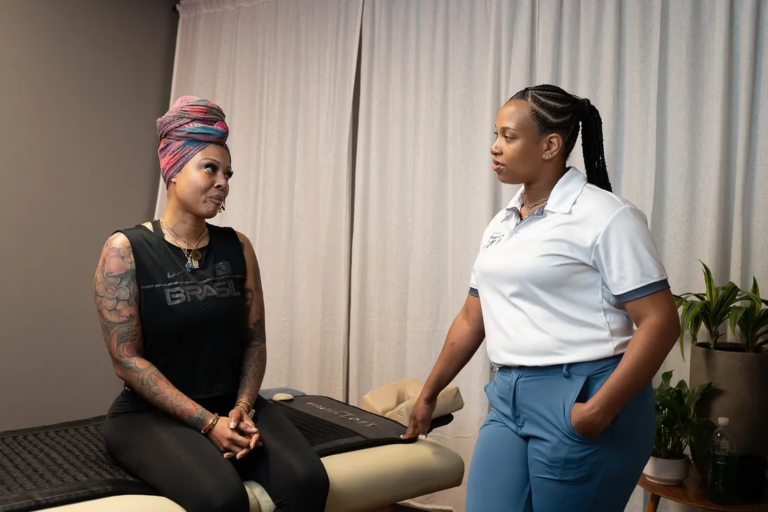 Practitioner and client talking face to face after a session